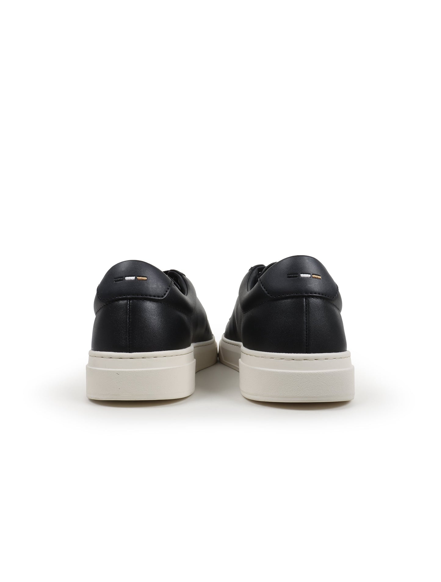 Black leather casual shoes with white soles on a white background