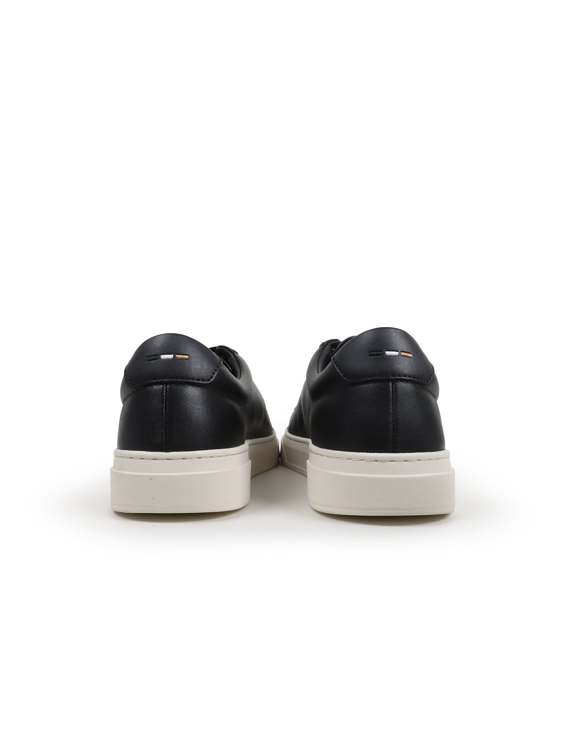 Black leather casual shoes with white soles on a white background